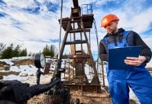 petroleum engineer inspecting pump jack oil field 651396 2144