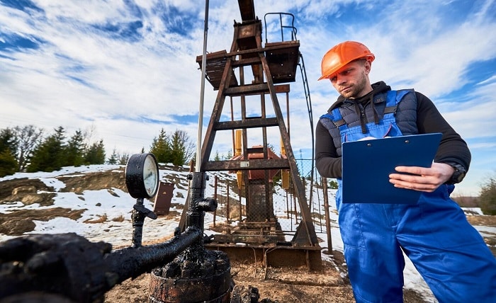 petroleum engineer inspecting pump jack oil field 651396 2144