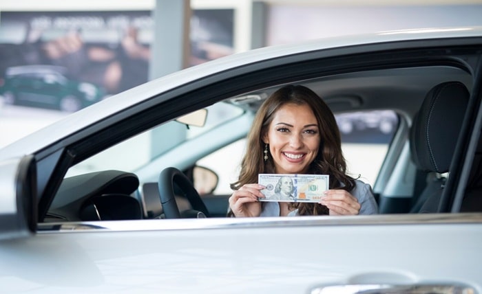 cheerful woman sitting new car holding us dollar banknote 342744 712