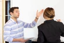 front view young attractive businesswoman black shirt along with young man discussing graphics desk while young lady presents her work reading document job building presentation 140725 16125