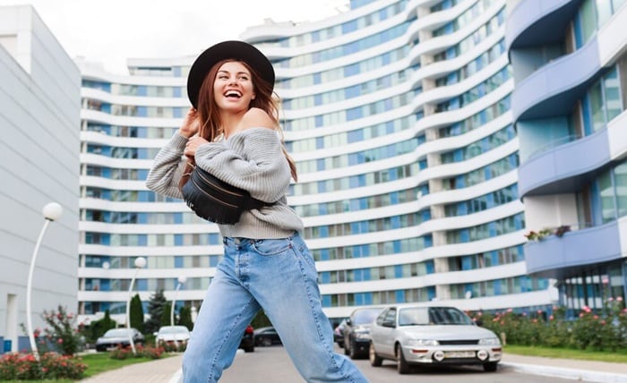 outdoor image joyful girl black wool hat grey fall sweater jumping enjoying walk modern urban city 273443 1874