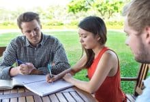 serious student friends doing homework outdoors 1262 3293