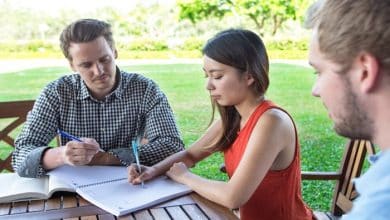 serious student friends doing homework outdoors 1262 3293