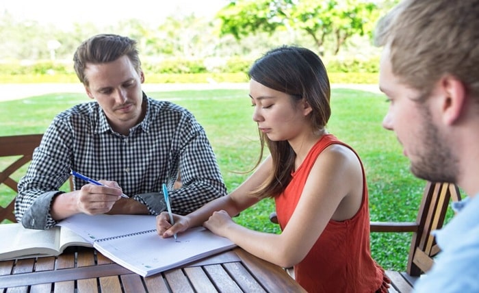 serious student friends doing homework outdoors 1262 3293