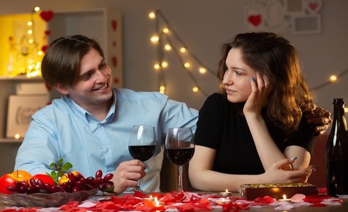 smiling handsome man holding glass wine looking pleased pretty woman sitting table living room valentine s day 141793 129778