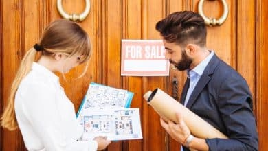 real estate agents waiting with plans front door 23 2147653368