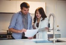 couple discussing digital tablet kitchen 107420 84887