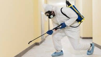 full shot man disinfecting building 23 2148926653