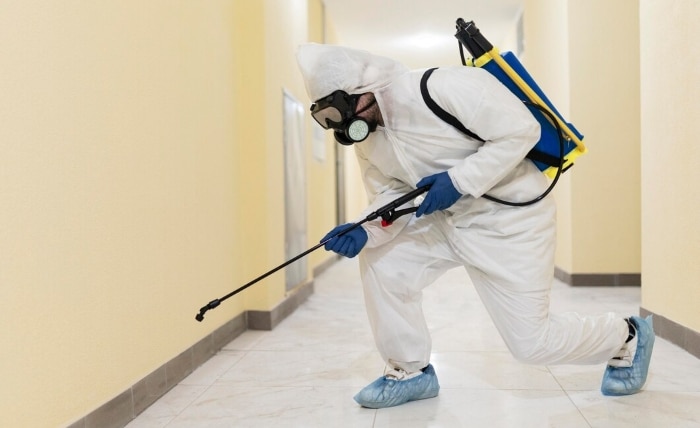 full shot man disinfecting building 23 2148926653