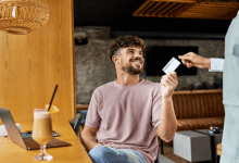 happy man paying the bill in a cafe