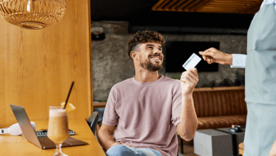 happy man paying the bill in a cafe
