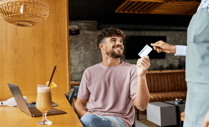 happy man paying the bill in a cafe