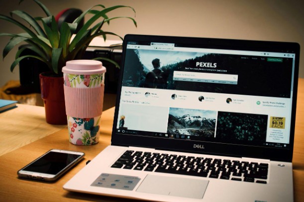 Photo of a Gray Dell Laptop Displaying Pexels Webpage